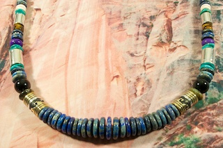 Beautiful  Necklace featuring Genuine Blue Lapis with Turquoise, Picture Jasper, Sugilite, Spiny Oyster Shell and Black Onyx. Sterling Silver and Gold Fill Barrels, Sterling Silver Beads and Clasp. Created by Navajo Artist Tommy Singer. Signed T. Singer.